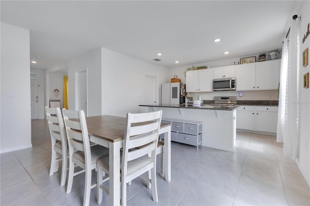1854 Juneberry St, Clermont, FL 34715 - dining area with light tile patterned floors and recessed lighting