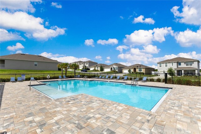 1854 Juneberry St, Clermont, FL 34715 - community pool with a residential view and a patio