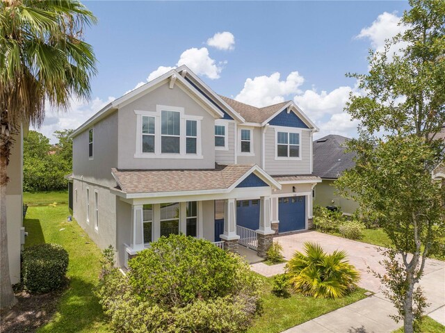 5161 Dove Tree St, Orlando, FL 32811 - view of front of house with concrete driveway, a porch, an attached garage, roof with shingles, and stucco siding