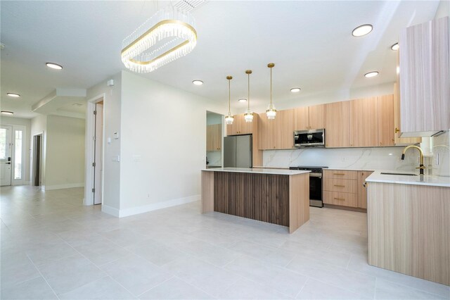 5161 Dove Tree St, Orlando, FL 32811 - kitchen featuring stainless steel appliances, a center island, light countertops, light tile patterned floors, and recessed lighting