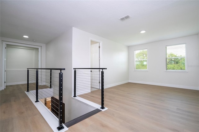 5161 Dove Tree St, Orlando, FL 32811 - hall with an upstairs landing, wood finished floors, and recessed lighting