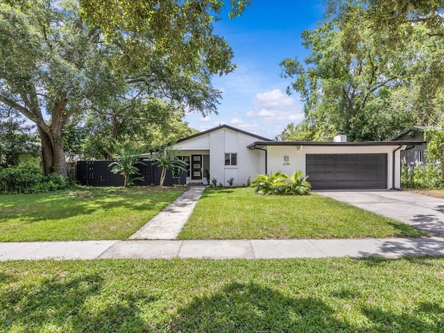 2244 Brookshire Ave, Winter Park, FL 32792 - mid-century modern home featuring a garage, driveway, and stucco siding
