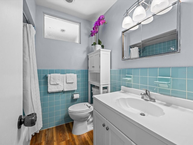 2244 Brookshire Ave, Winter Park, FL 32792 - bathroom featuring tile walls, wood finished floors, vanity, a shower with curtain, and wainscoting