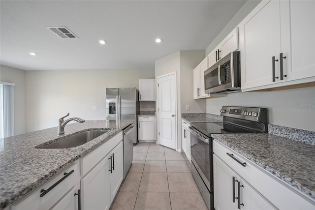 489 Panaro Ln, Haines City, FL 33844 - kitchen featuring appliances with stainless steel finishes, a sink, white cabinetry, recessed lighting, and light tile patterned flooring