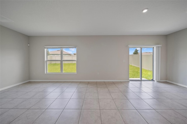 489 Panaro Ln, Haines City, FL 33844 - empty room with plenty of natural light, light tile patterned flooring, and recessed lighting