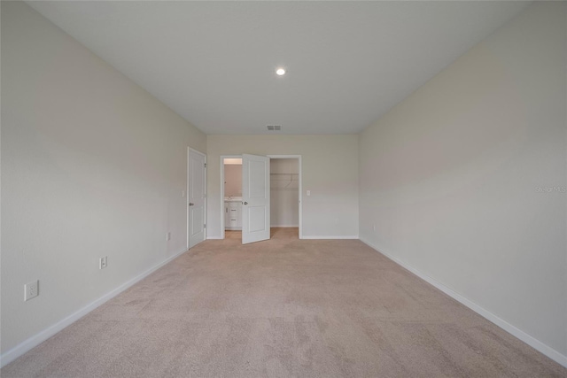 489 Panaro Ln, Haines City, FL 33844 - unfurnished bedroom with light carpet, a spacious closet, recessed lighting, and a closet