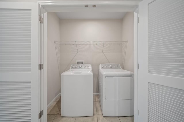 489 Panaro Ln, Haines City, FL 33844 - laundry area with washer and clothes dryer and light tile patterned flooring