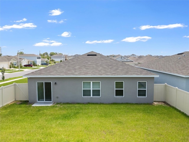 489 Panaro Ln, Haines City, FL 33844 - back of property with a shingled roof, stucco siding, and a residential view