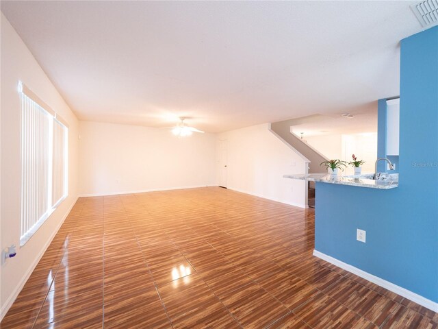 8330 Lainie Ln, Orlando, FL 32818 - empty room featuring stairway, ceiling fan, and wood finished floors