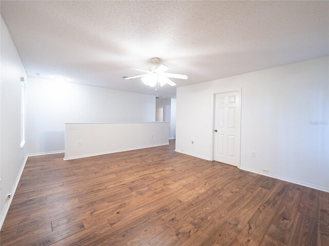 8330 Lainie Ln, Orlando, FL 32818 - unfurnished room with wood finished floors, a ceiling fan, and a textured ceiling