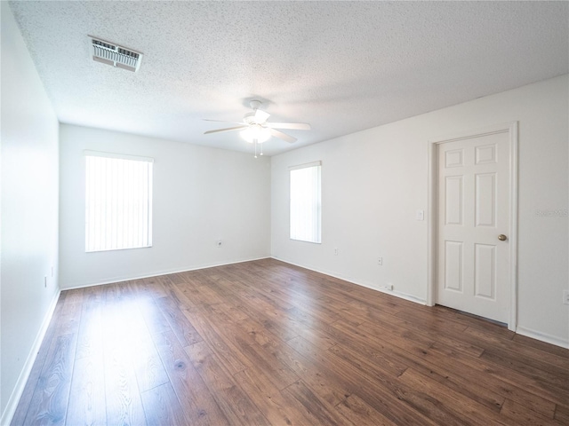 8330 Lainie Ln, Orlando, FL 32818 - empty room with a ceiling fan, dark wood-style floors, and a textured ceiling