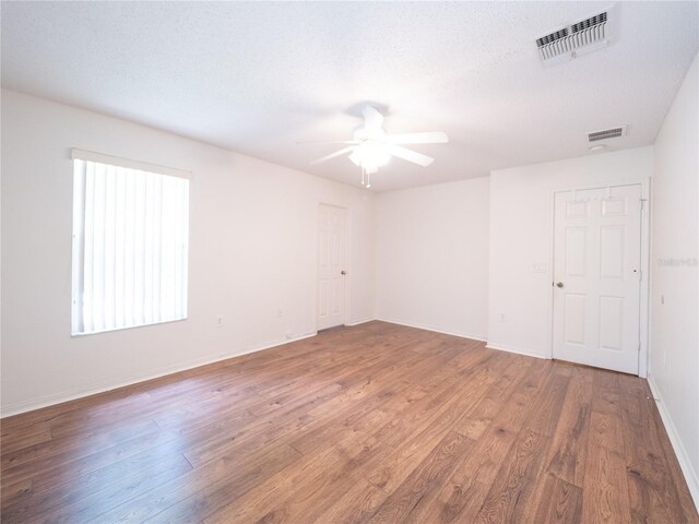 8330 Lainie Ln, Orlando, FL 32818 - empty room featuring ceiling fan and wood finished floors