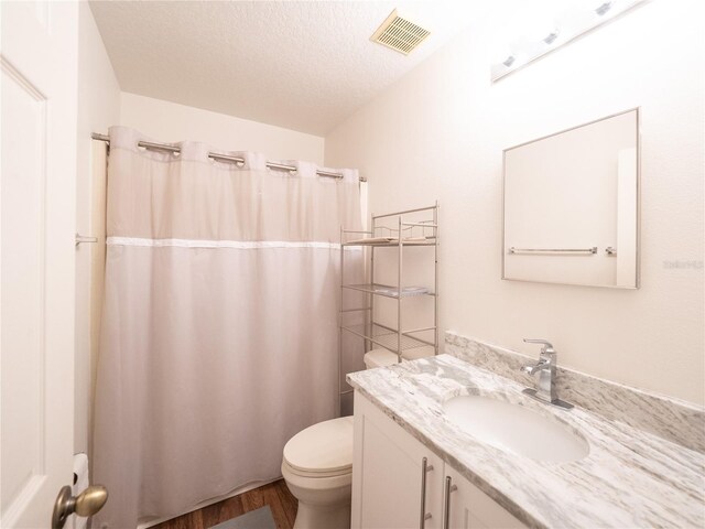 8330 Lainie Ln, Orlando, FL 32818 - full bathroom featuring vanity, wood finished floors, and a textured ceiling