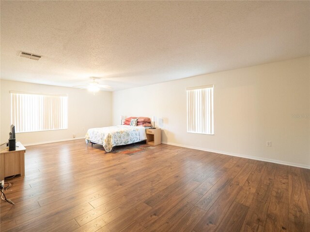 8330 Lainie Ln, Orlando, FL 32818 - bedroom with hardwood / wood-style flooring, a textured ceiling, and a ceiling fan