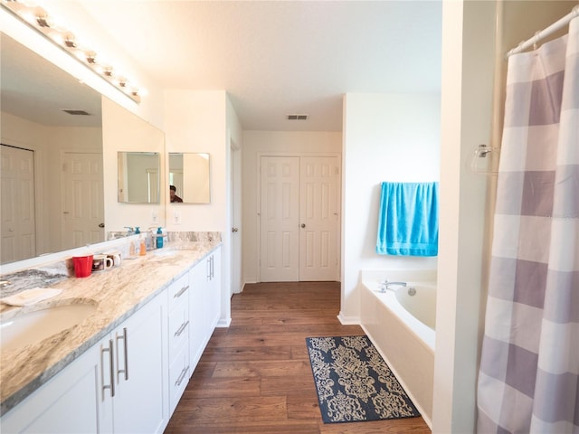 8330 Lainie Ln, Orlando, FL 32818 - full bath featuring double vanity, wood finished floors, a garden tub, and curtained shower