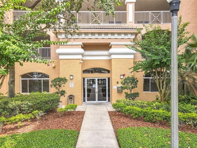 6336 Buford St Unit 207, Orlando, FL 32835 - property entrance with a balcony, french doors, and stucco siding