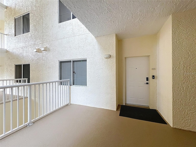6336 Buford St Unit 207, Orlando, FL 32835 - view of exterior entry featuring a balcony and stucco siding