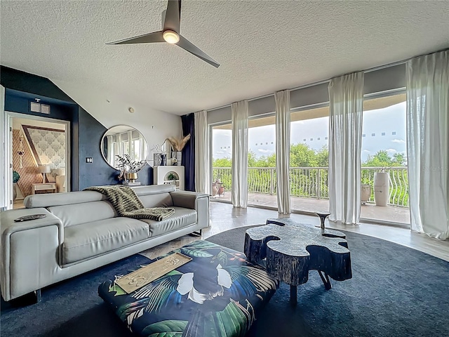 6336 Buford St Unit 207, Orlando, FL 32835 - living area with a textured ceiling, a ceiling fan, and plenty of natural light