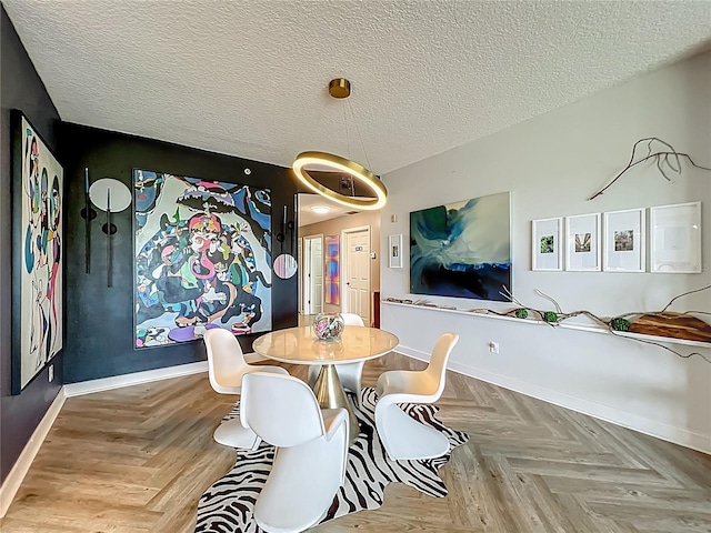 6336 Buford St Unit 207, Orlando, FL 32835 - dining space featuring baseboards and a textured ceiling