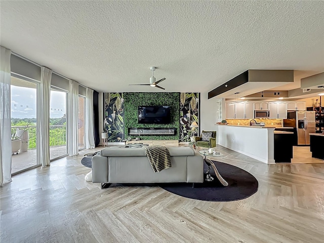 6336 Buford St Unit 207, Orlando, FL 32835 - living area featuring a ceiling fan and a textured ceiling