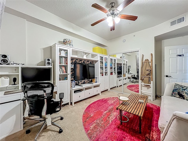 6336 Buford St Unit 207, Orlando, FL 32835 - carpeted living area featuring a desk, a ceiling fan, a textured ceiling, and french doors