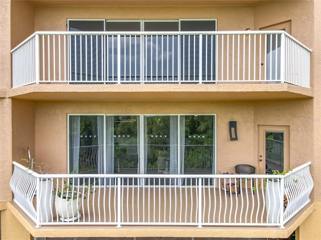 6336 Buford St Unit 207, Orlando, FL 32835 - rear view of property with a balcony and stucco siding
