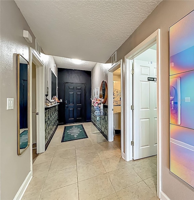 6336 Buford St Unit 207, Orlando, FL 32835 - entryway with light tile patterned flooring and a textured ceiling