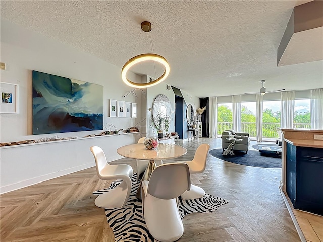6336 Buford St Unit 207, Orlando, FL 32835 - dining space featuring a textured ceiling and baseboards