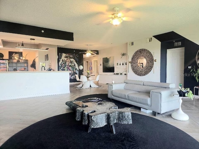6336 Buford St Unit 207, Orlando, FL 32835 - living room with a ceiling fan and a textured ceiling