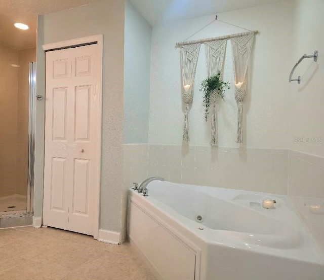 6336 Buford St Unit 207, Orlando, FL 32835 - bathroom with a whirlpool tub, tile patterned floors, and an enclosed shower