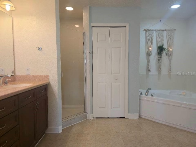 6336 Buford St Unit 207, Orlando, FL 32835 - bathroom with vanity, a stall shower, a garden tub, recessed lighting, and tile patterned flooring