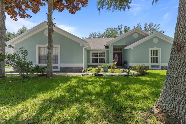 36646 Oconee Ave, Eustis, FL 32736 - ranch-style house with stucco siding, a front lawn, and stone siding