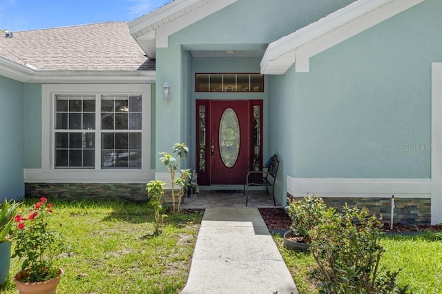 36646 Oconee Ave, Eustis, FL 32736 - entrance to property with roof with shingles, a lawn, and stucco siding