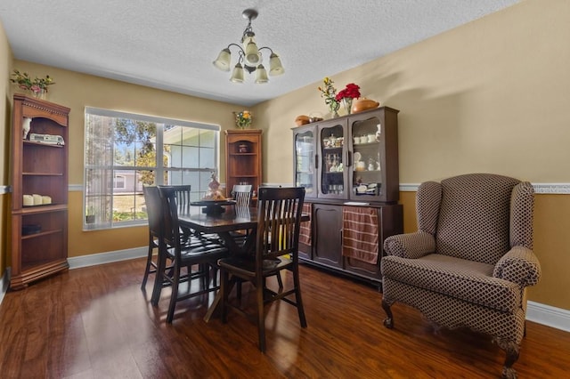 36646 Oconee Ave, Eustis, FL 32736 - dining space with a chandelier, dark wood-style floors, baseboards, and a textured ceiling