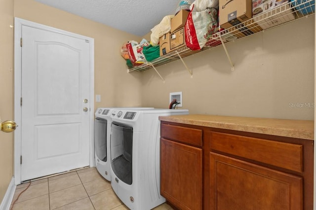 36646 Oconee Ave, Eustis, FL 32736 - washroom with washing machine and dryer, light tile patterned floors, cabinet space, and a textured ceiling