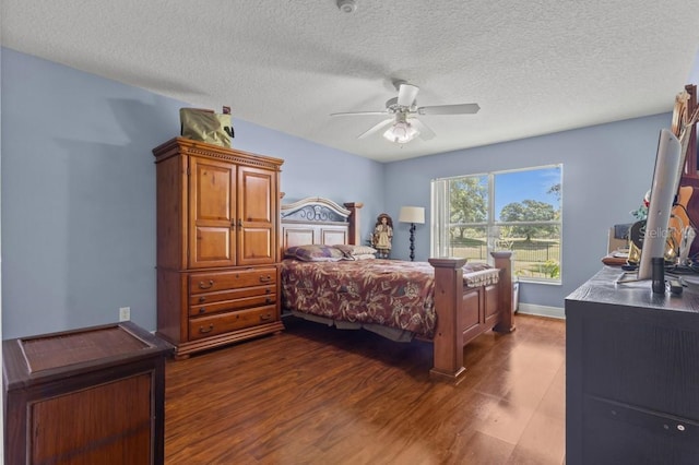 36646 Oconee Ave, Eustis, FL 32736 - bedroom featuring dark wood-style flooring, a textured ceiling, and a ceiling fan