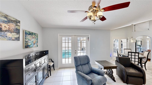 14723 Pine Cone Trl, Clermont, FL 34711 - living area with ceiling fan, plenty of natural light, a textured ceiling, french doors, and light tile patterned floors
