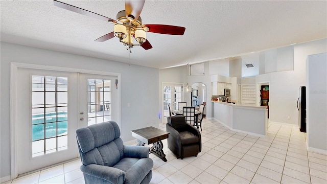 14723 Pine Cone Trl, Clermont, FL 34711 - sitting room with a textured ceiling, light tile patterned floors, ceiling fan, and french doors