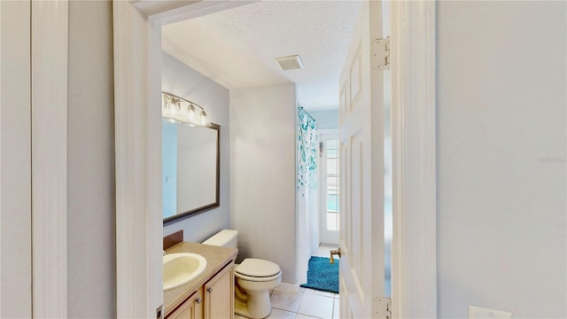 14723 Pine Cone Trl, Clermont, FL 34711 - bathroom with vanity, a textured ceiling, and tile patterned flooring