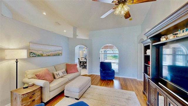 14723 Pine Cone Trl, Clermont, FL 34711 - living room featuring arched walkways, a ceiling fan, and wood finished floors