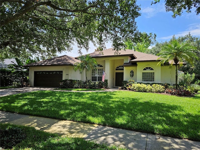 9491 Wickham Way, Orlando, FL 32836 - single story home with an attached garage, concrete driveway, a front lawn, and stucco siding