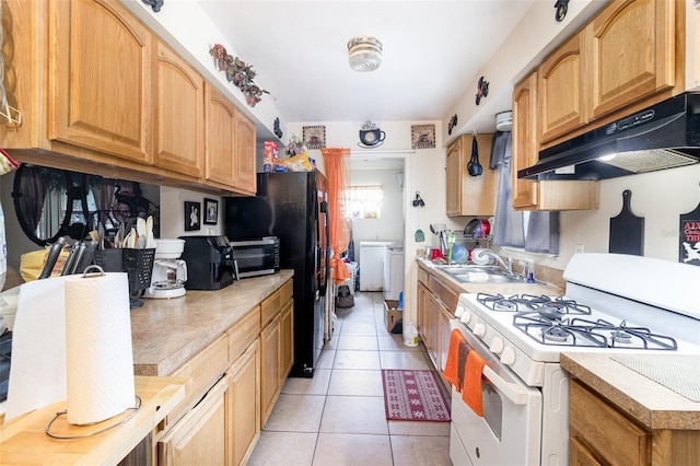987 Alsup Dr, Rockledge, FL 32955 - kitchen featuring white range with gas stovetop, separate washer and dryer, under cabinet range hood, and light countertops