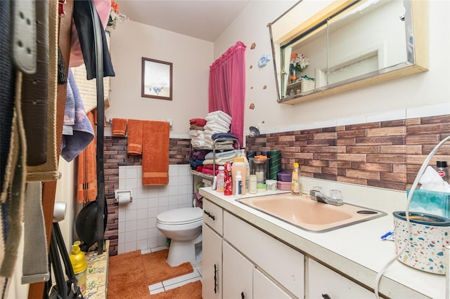 987 Alsup Dr, Rockledge, FL 32955 - bathroom featuring tile walls, vanity, tile patterned flooring, and a wainscoted wall