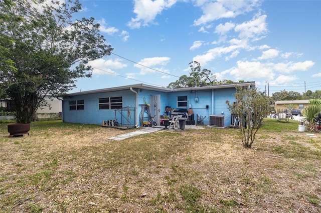 987 Alsup Dr, Rockledge, FL 32955 - rear view of property featuring a yard and concrete block siding