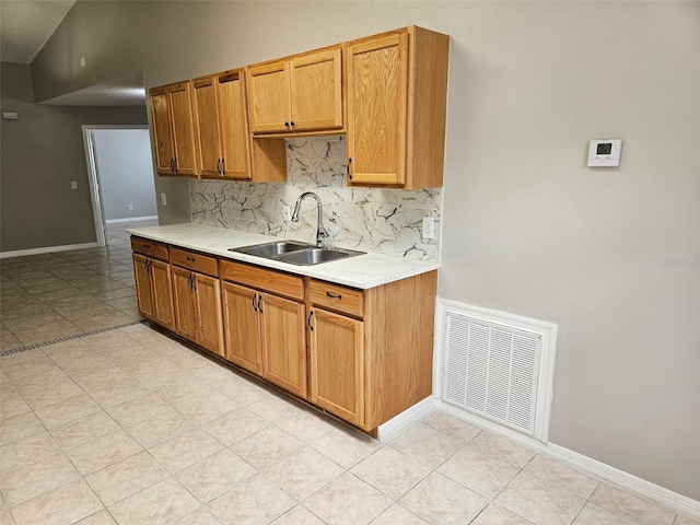304 Lake Daisy Loop, Winter Haven, FL 33884 - kitchen with a sink, light countertops, backsplash, and baseboards