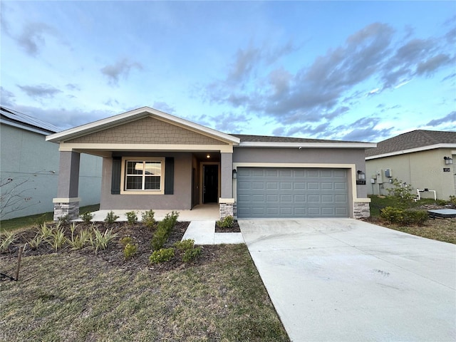 1147 Pomelo St, Davenport, FL 33837 - view of front of home featuring stucco siding, a garage, concrete driveway, and stone siding