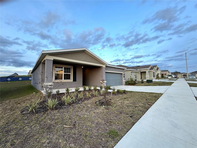 1147 Pomelo St, Davenport, FL 33837 - view of front of property featuring stucco siding, concrete driveway, and a garage