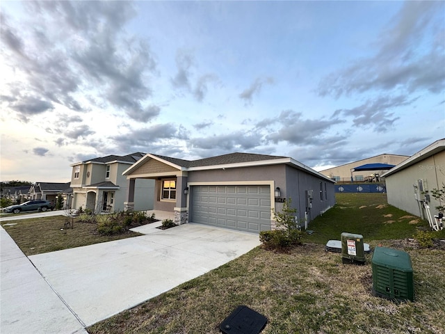 1147 Pomelo St, Davenport, FL 33837 - view of front of house featuring an attached garage, driveway, stucco siding, and a front yard