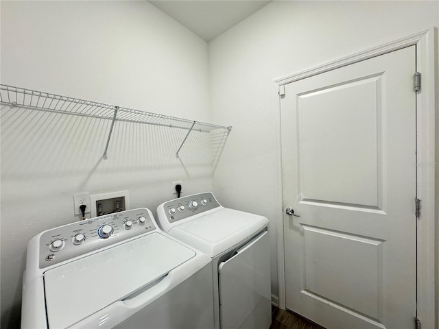 1147 Pomelo St, Davenport, FL 33837 - washroom with washer and clothes dryer and dark wood-type flooring