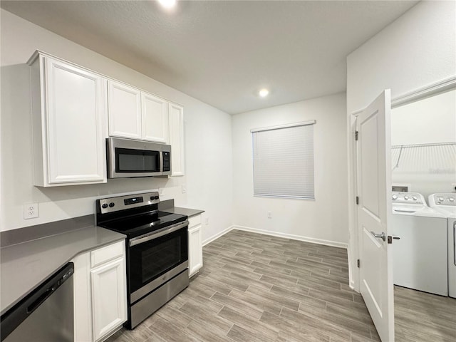 1147 Pomelo St, Davenport, FL 33837 - kitchen with stainless steel appliances, washing machine and dryer, light wood-style flooring, white cabinetry, and recessed lighting